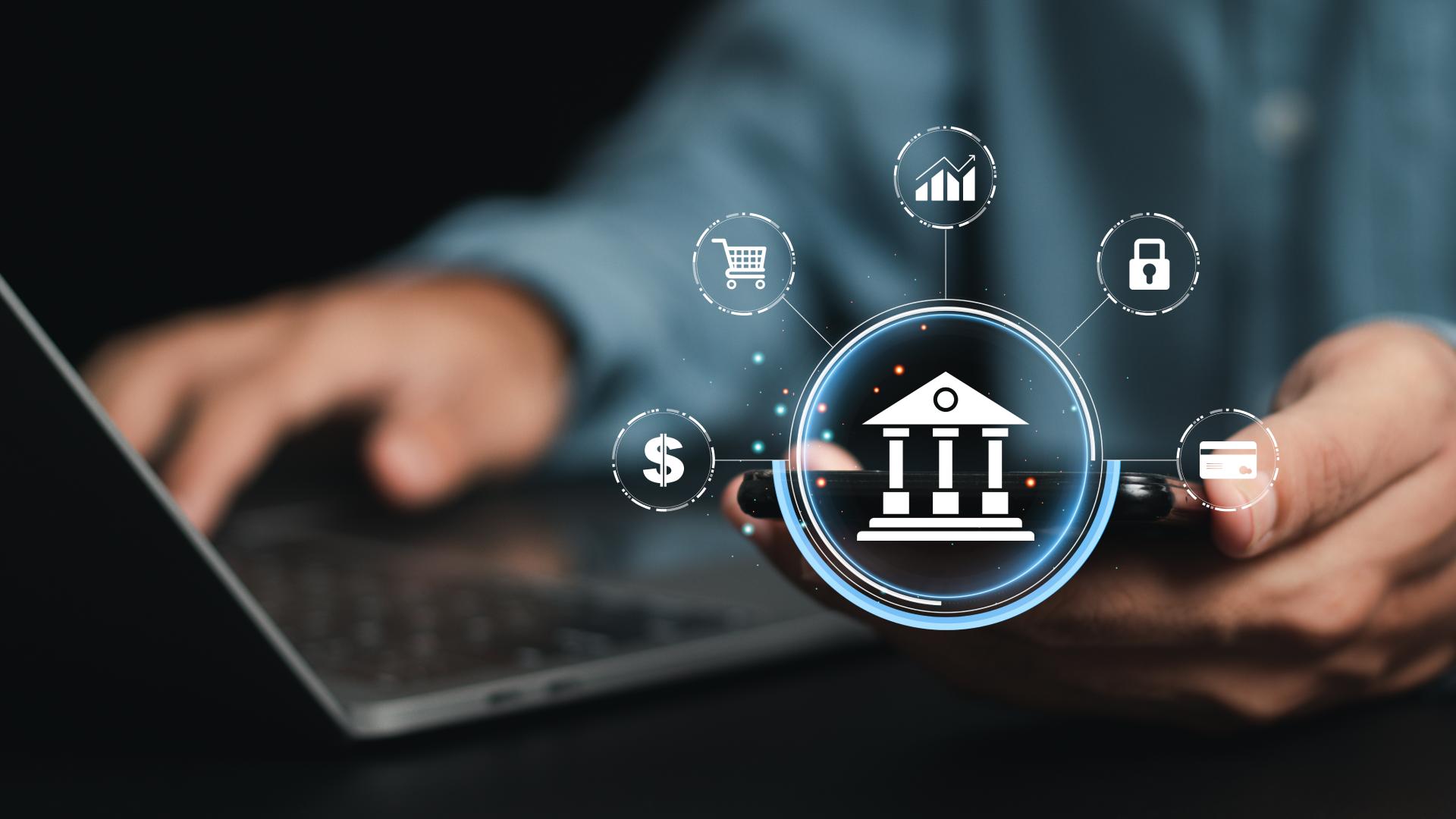 Pessoa usando notebook e smartphone com ícones digitais de banco, cartão, segurança e finanças, representando o conceito de Banking as a Service e a integração de serviços financeiros via tecnologia.